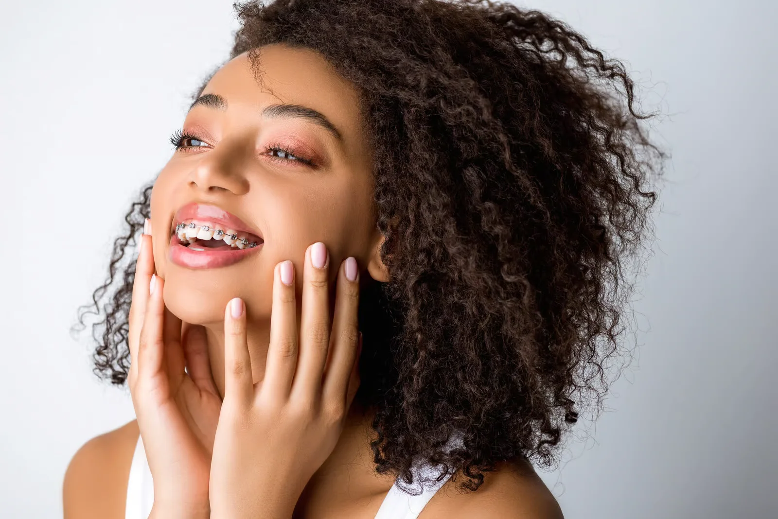 Smiling young woman showing off her new braces